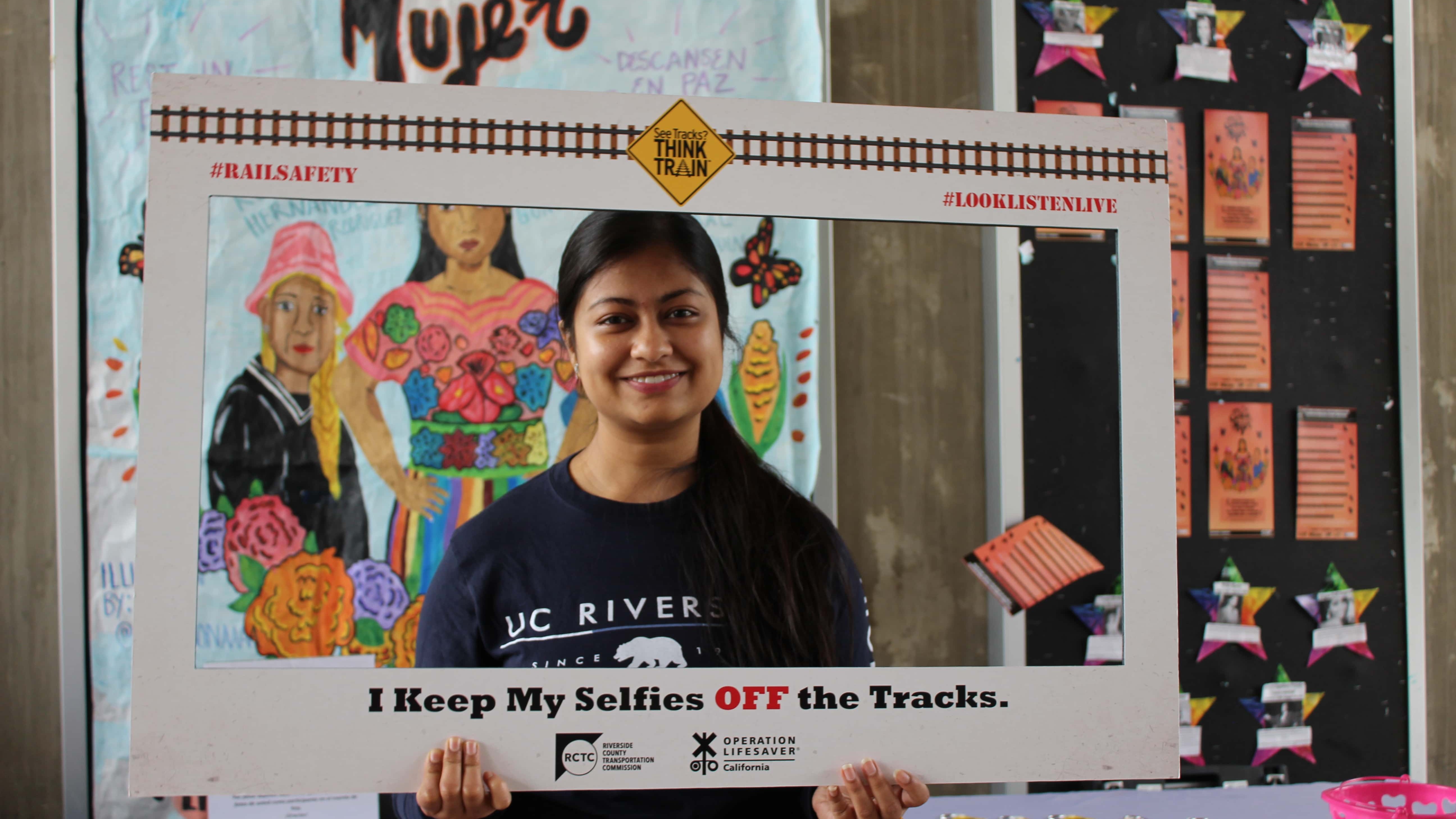 Photo of a student holding a rail safety frame.