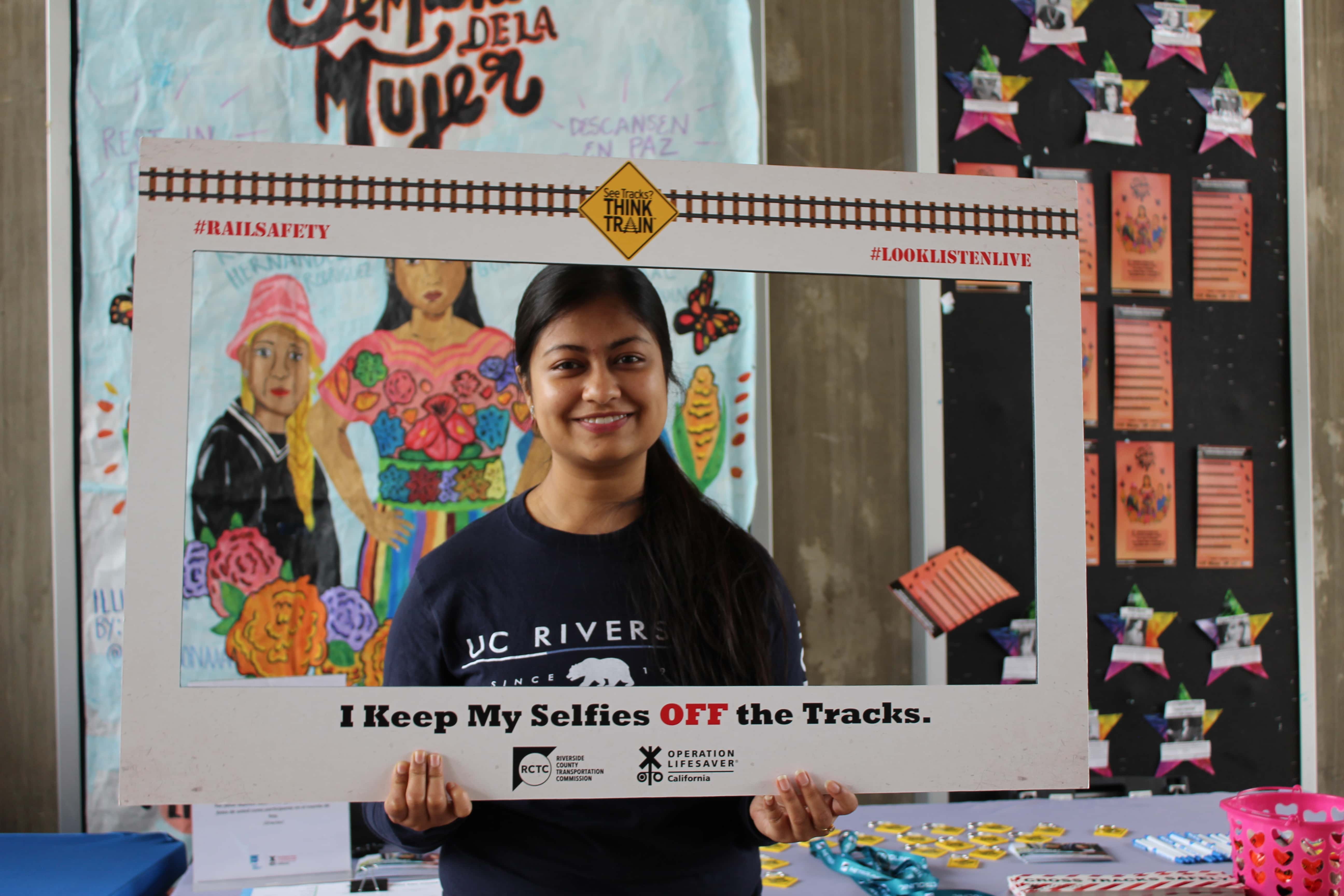 Photo of a student holding a rail safety frame.