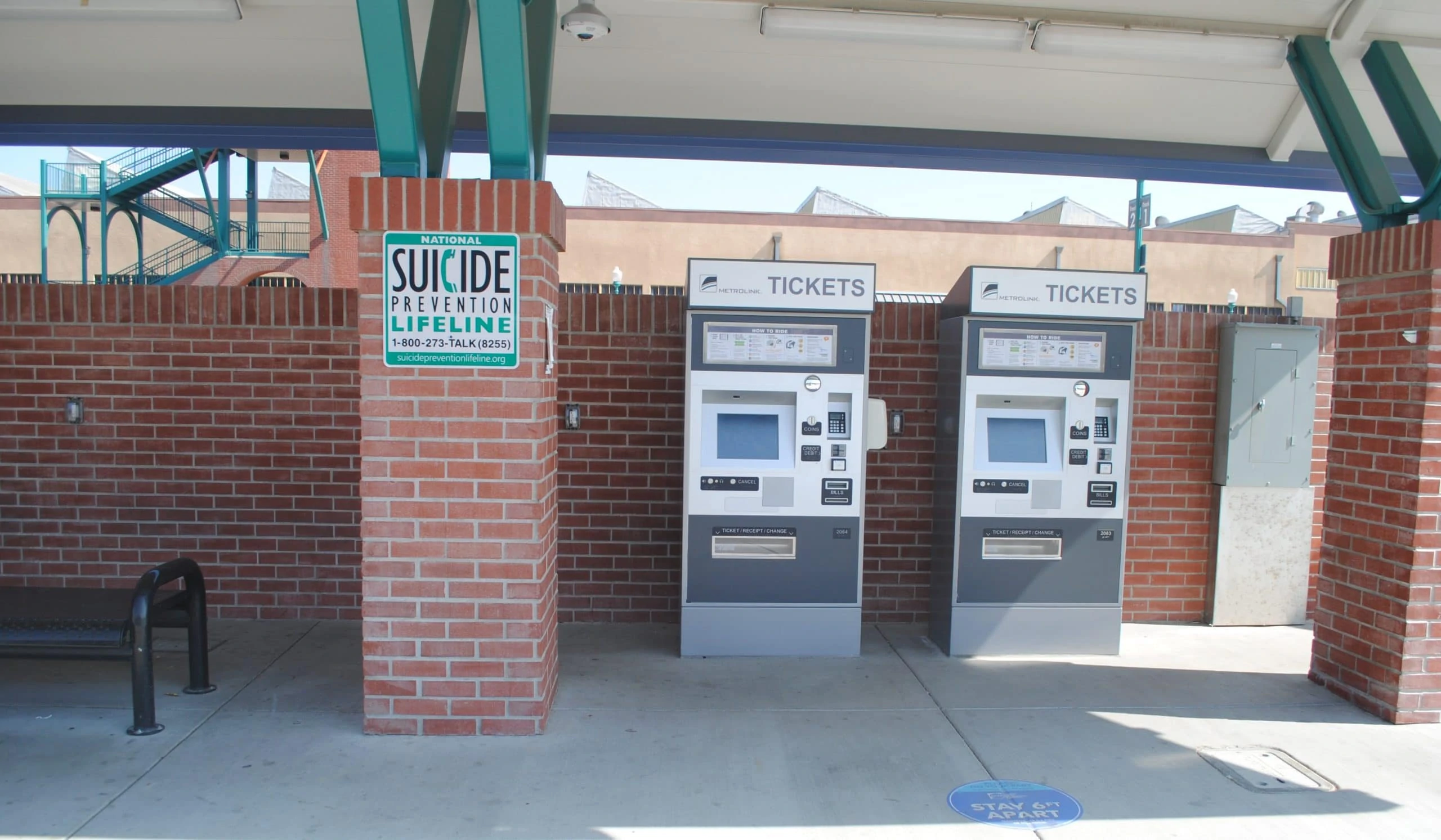 Suicide prevention lifeline sign next to Metrolink train ticket stations