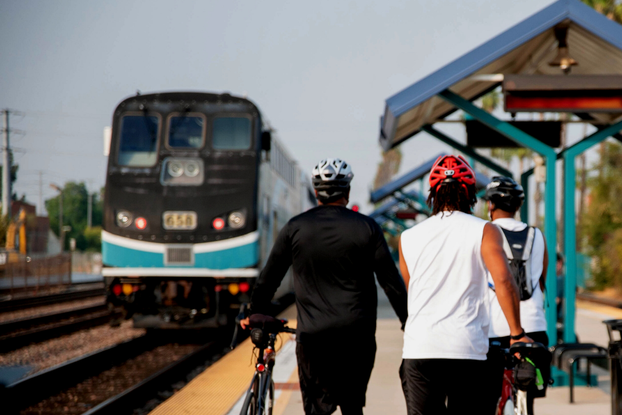 Metrolink train approaching with cyclists in the forefront