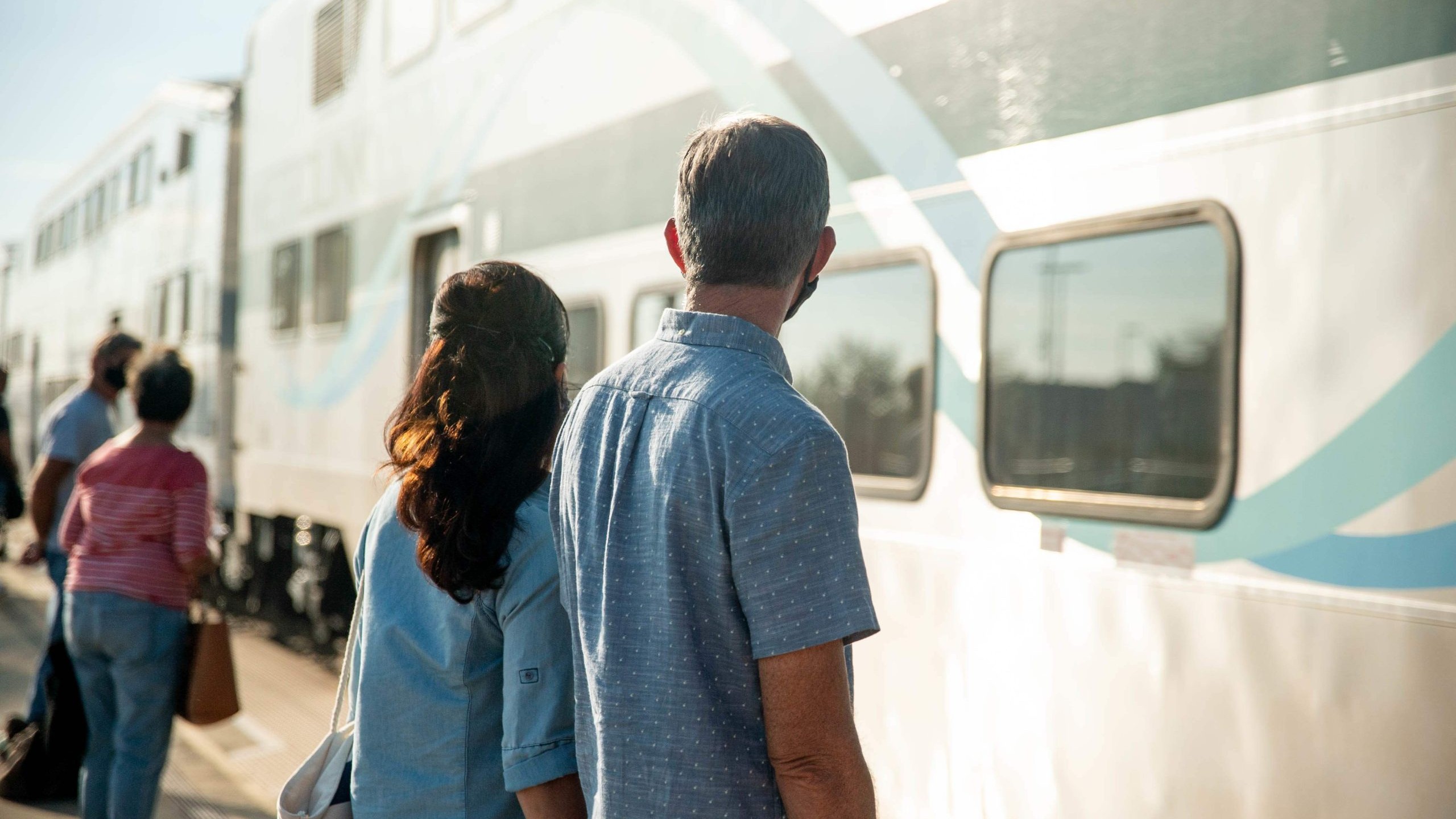 Older couple waiting to board train