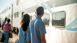 Older couple waiting to board train
