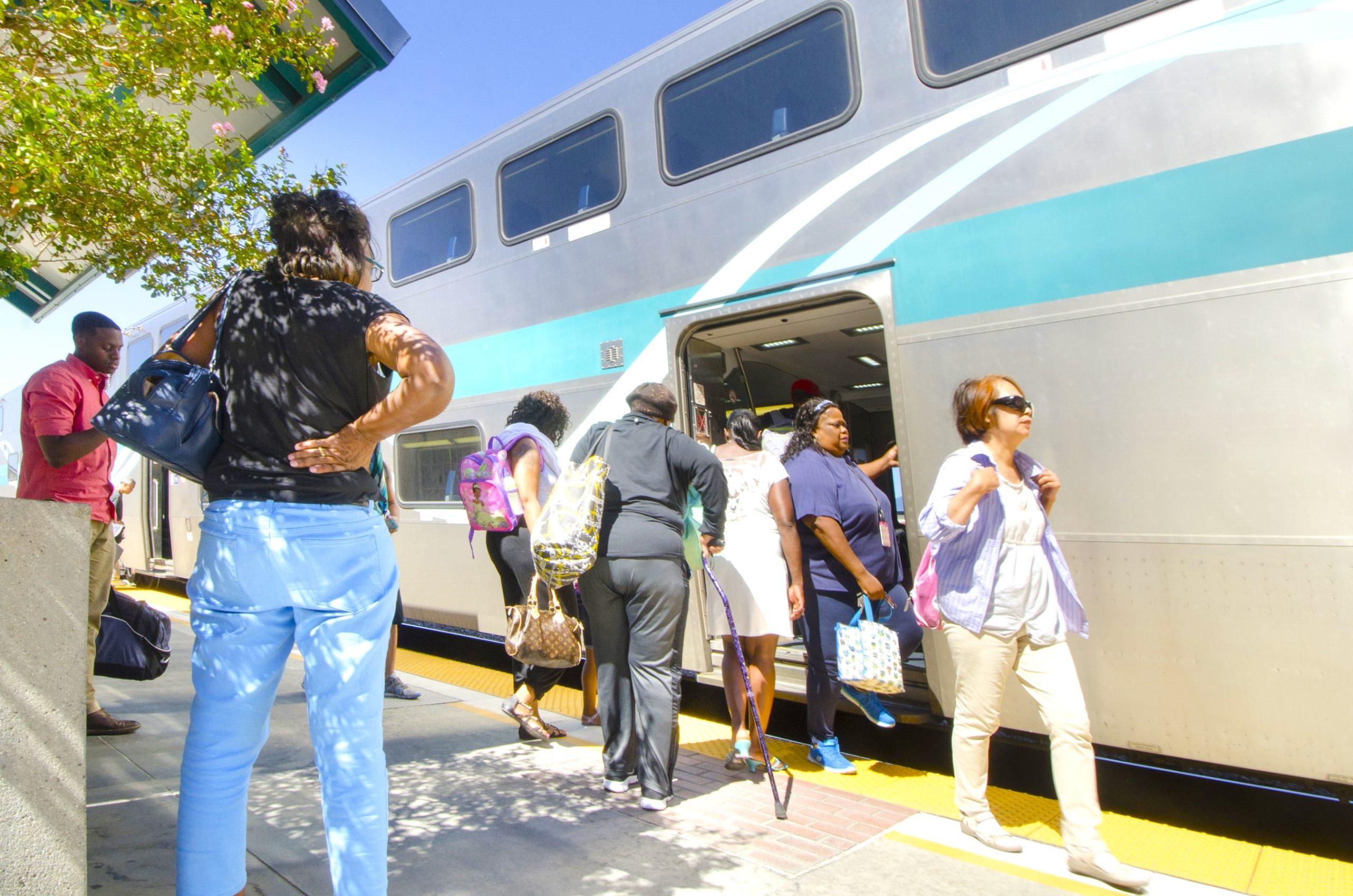 Passengers board the Metrolink train at the Riverside-Downtown station